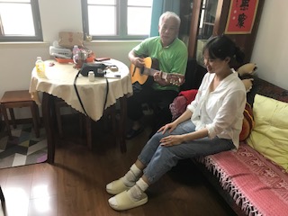 DDA's Wang Ming Bo serenading the 'Beijing Review' producer as we "enjoyed" acupuncture at his home! 